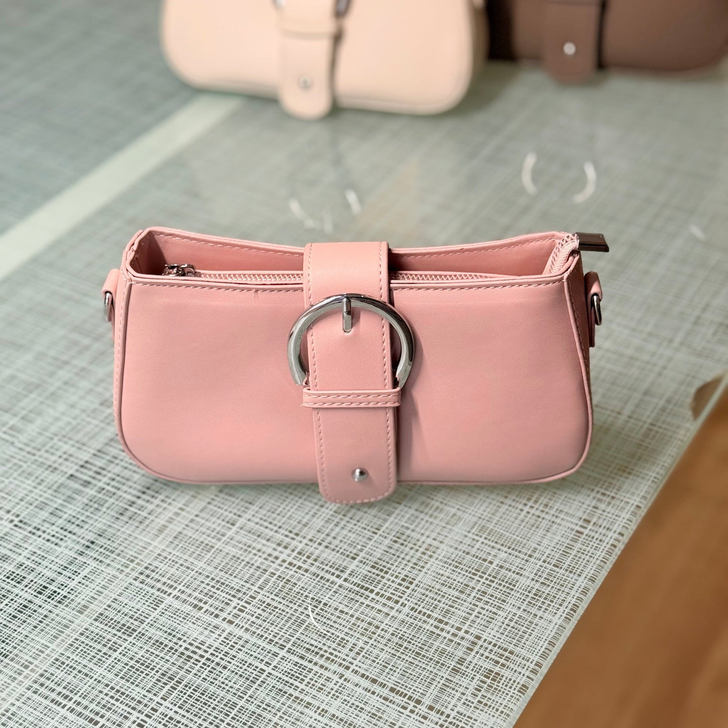 Pink handbag with a silver buckle